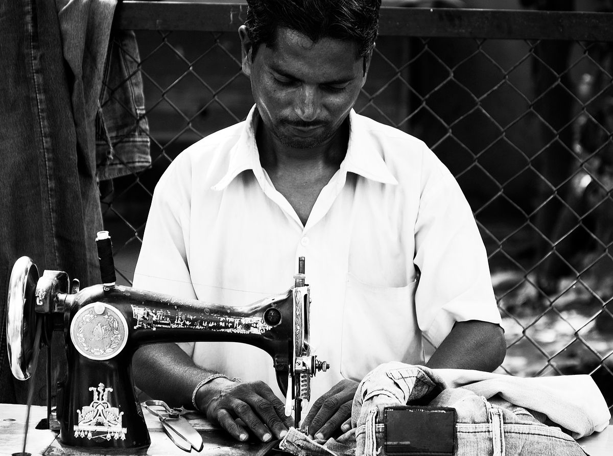 tailoring, stiching the garment, stichig machine, man portrait