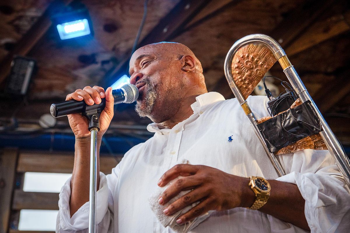 Performance photography capturing Jeff Bradshaw singing and playing trombone during a live music event in Philadelphia, showcasing musical mastery and cultural vibrance.
