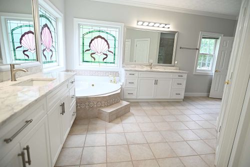 Illuminated bathroom with stained glass,and soaking tub
