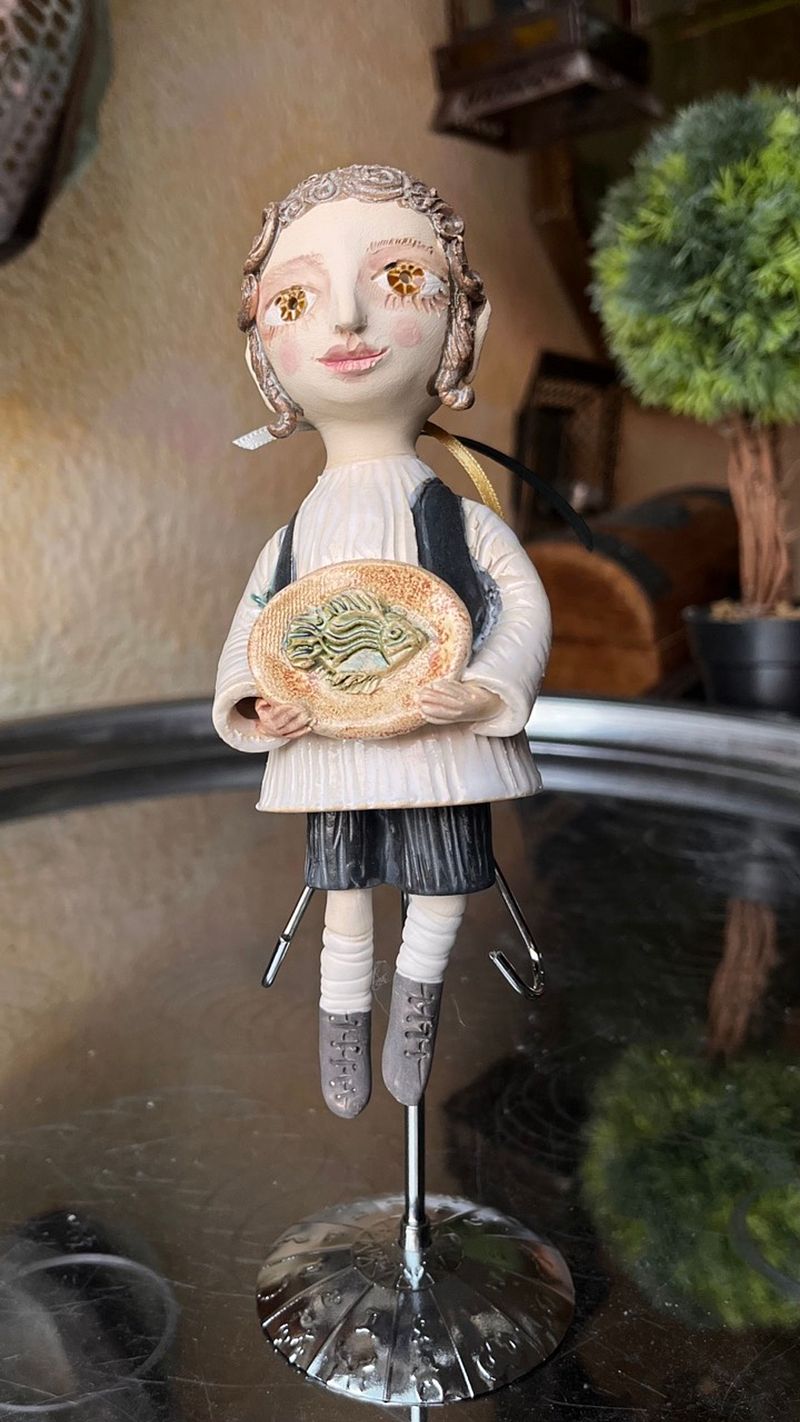 Traditional boy with a fish, little ceramic hanging sculpture