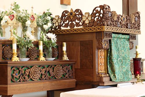 Custom hand-carved tabernacle with vines, flowers, and symbolic birds by Wes and Kelly Baker for St. Bernadette Catholic Church