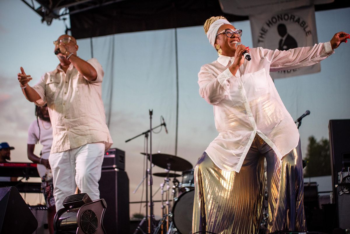 Live performance photography capturing Kindred the Family Soul on stage during a Philadelphia community celebration, highlighting musical artistry, audience energy, and cultural connection.