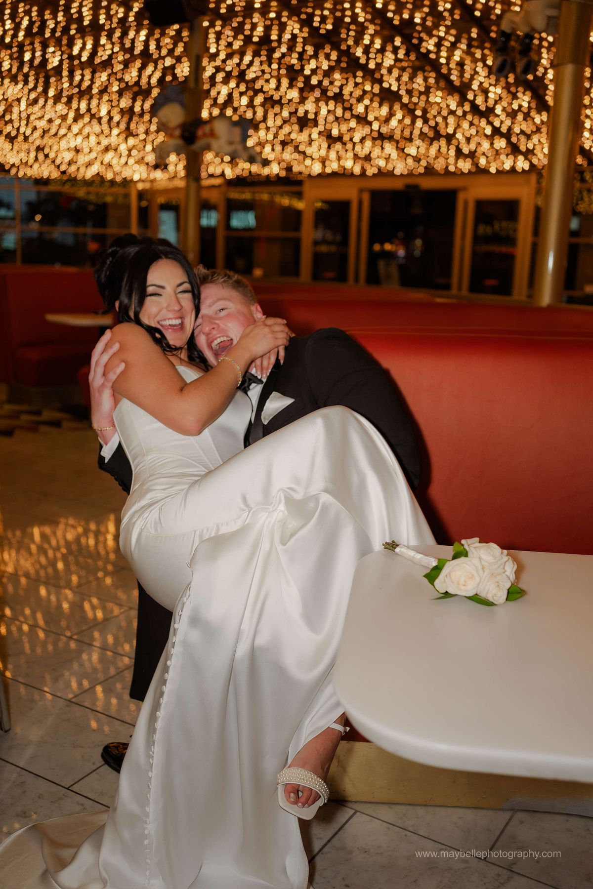 Romantic elopement photos at Carousel Bar in Downtown Las Vegas with couple celebrating with champagne