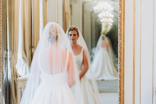 Bride looking in mirror