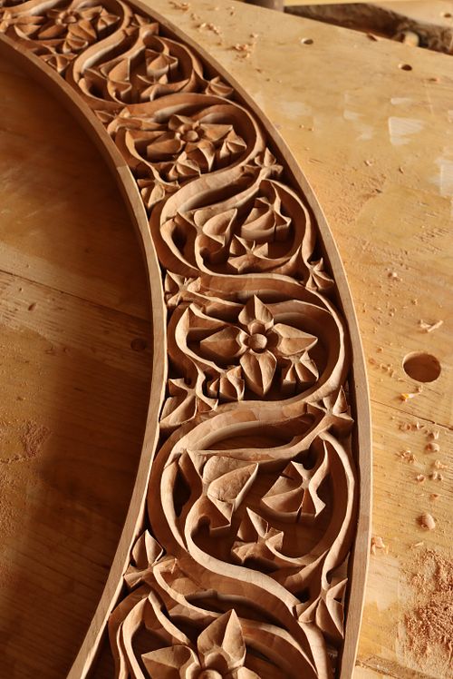 detail of scrolling vine carving with virgin's bower flowers in arch to go over Sisters' tabernacle