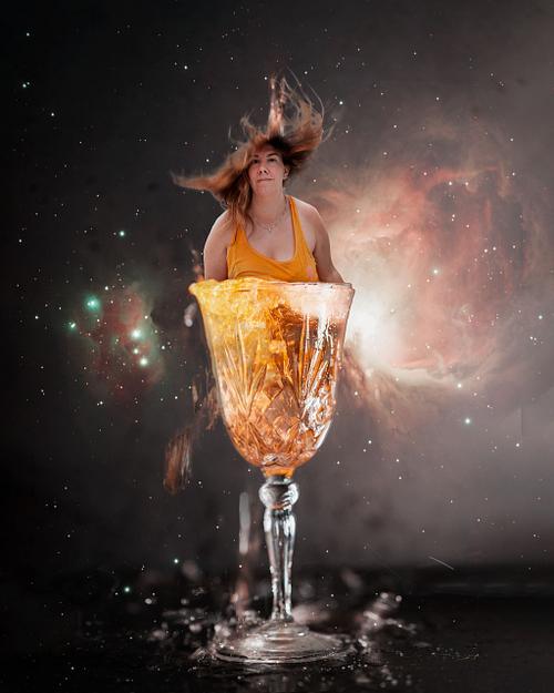 A woman bursting out of a champagne glass.