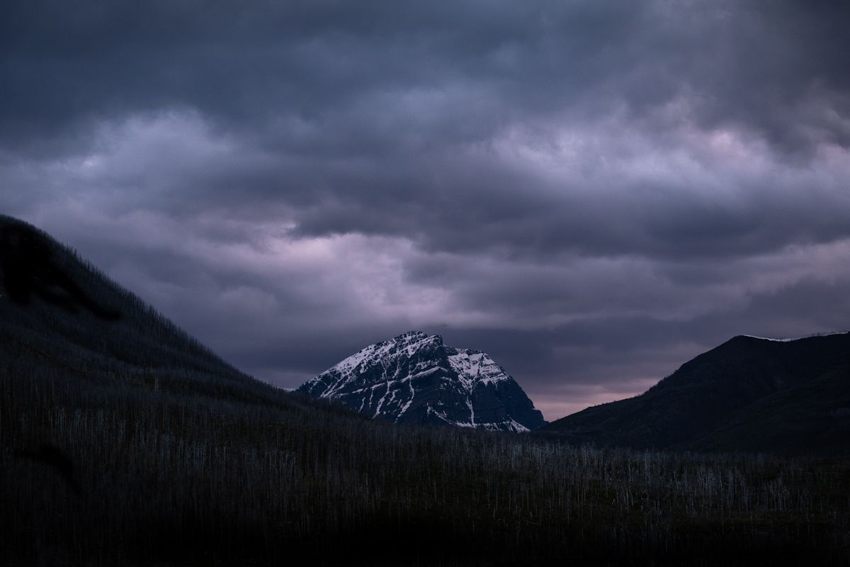 Moody sunset clouds over a mountain peak in Waterton Lakes National Park