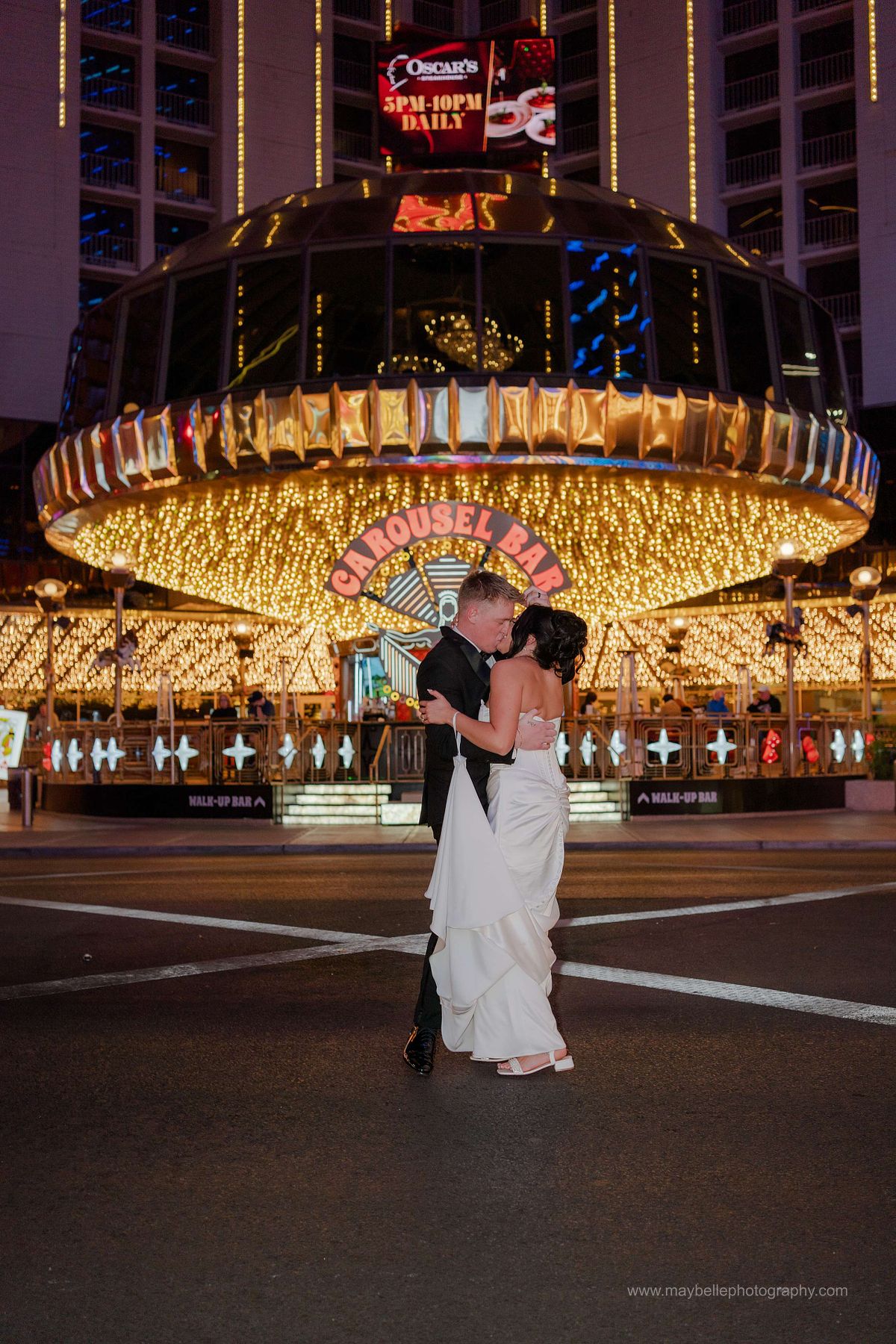 Romantic elopement photos at Carousel Bar in Downtown Las Vegas with couple celebrating with champagne