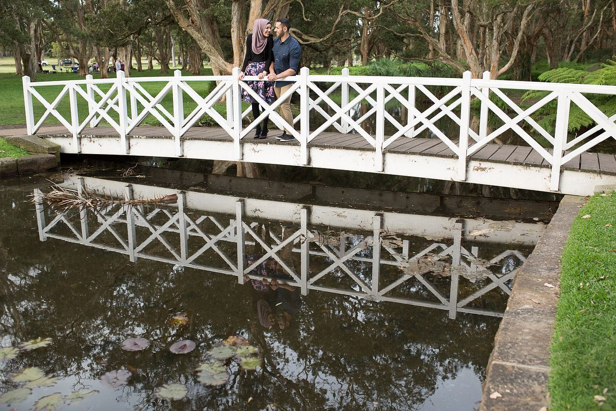Engaged couple in the middle of the bridge at Duck Pond, Centennial Park