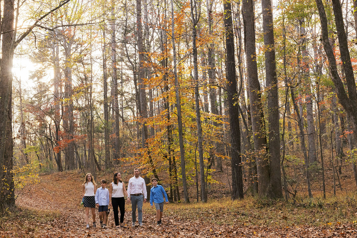 A family walking through a clearing in Carolina North Forest near Carrboro