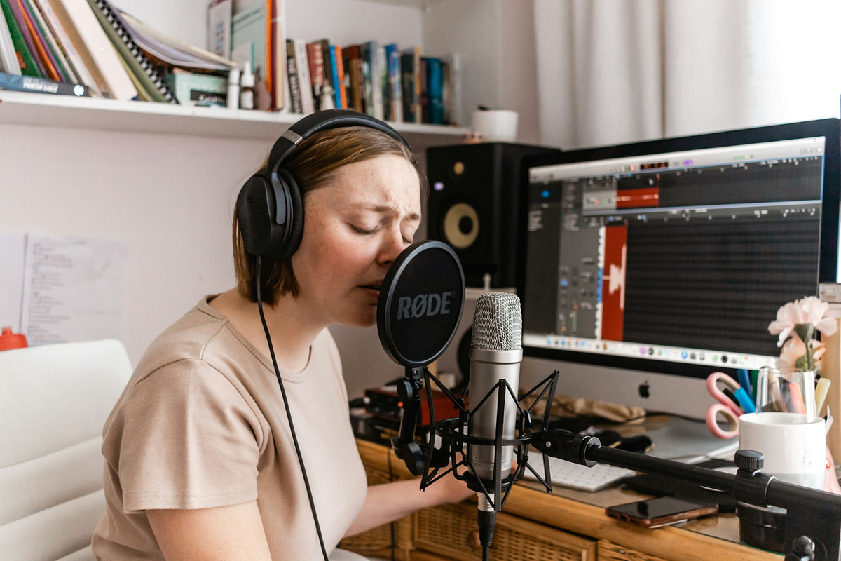 a woman recording in her small home studio