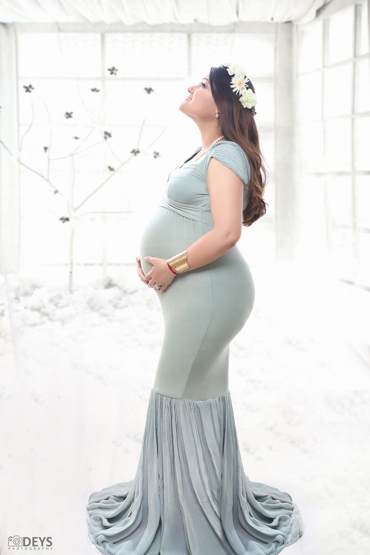 Beautiful mom green mermaid gown maternity shoot at studio