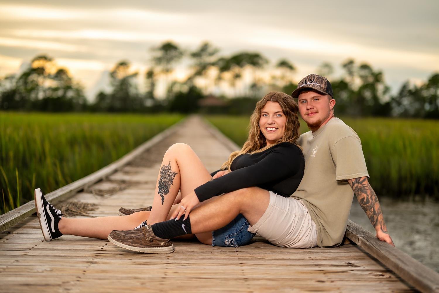 Couple on a wooden bridge at Hunting Island State Park during an engagement session
