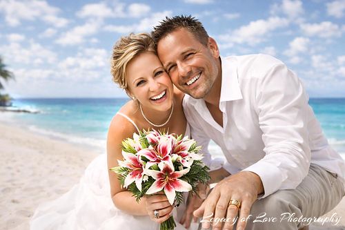 Happy wedding couple embracing on a sandy St. Augustine beach with turquoise ocean in Northeast Florida.