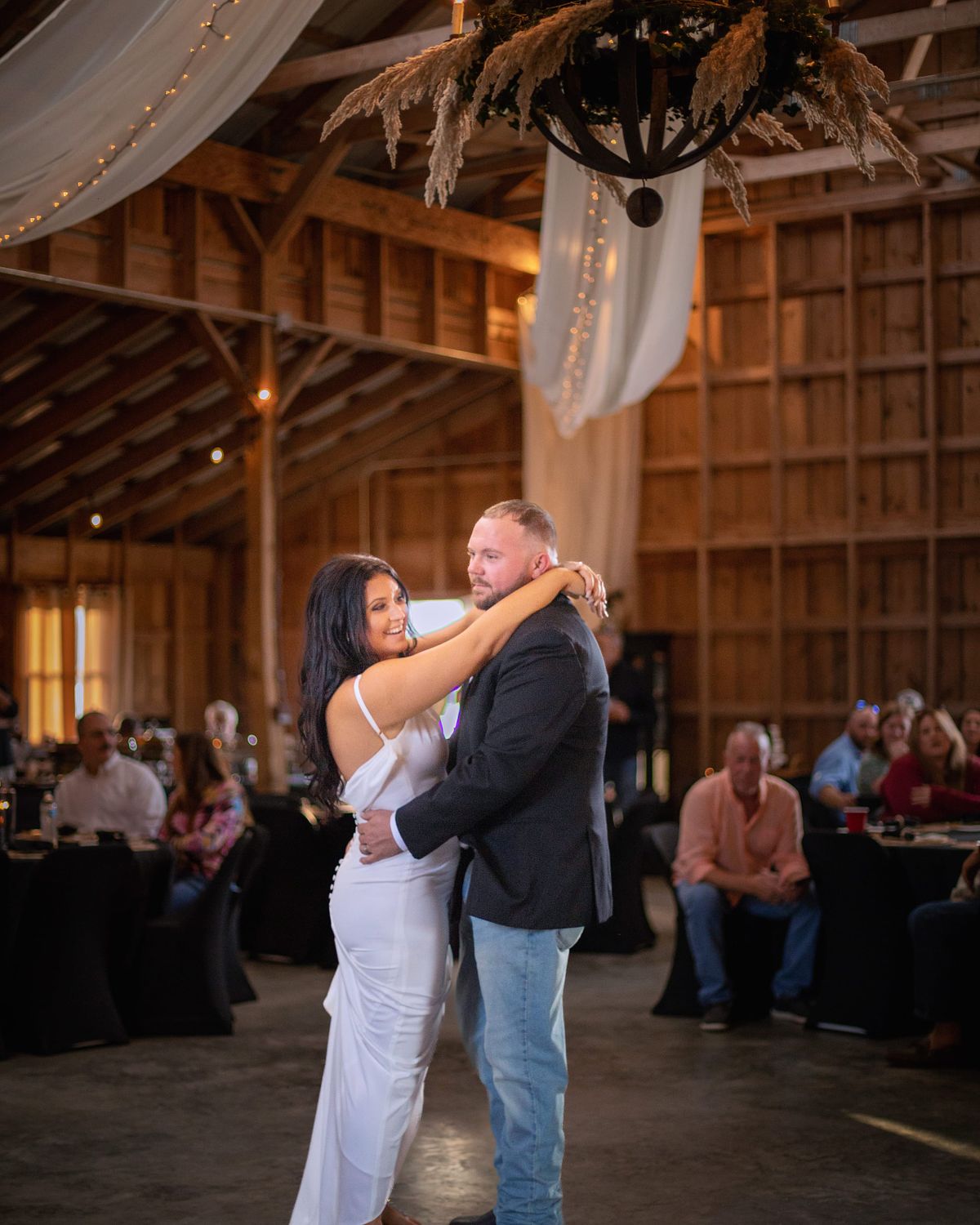 Couple dancing indoors at a cohee barn in Williamsburg, Md