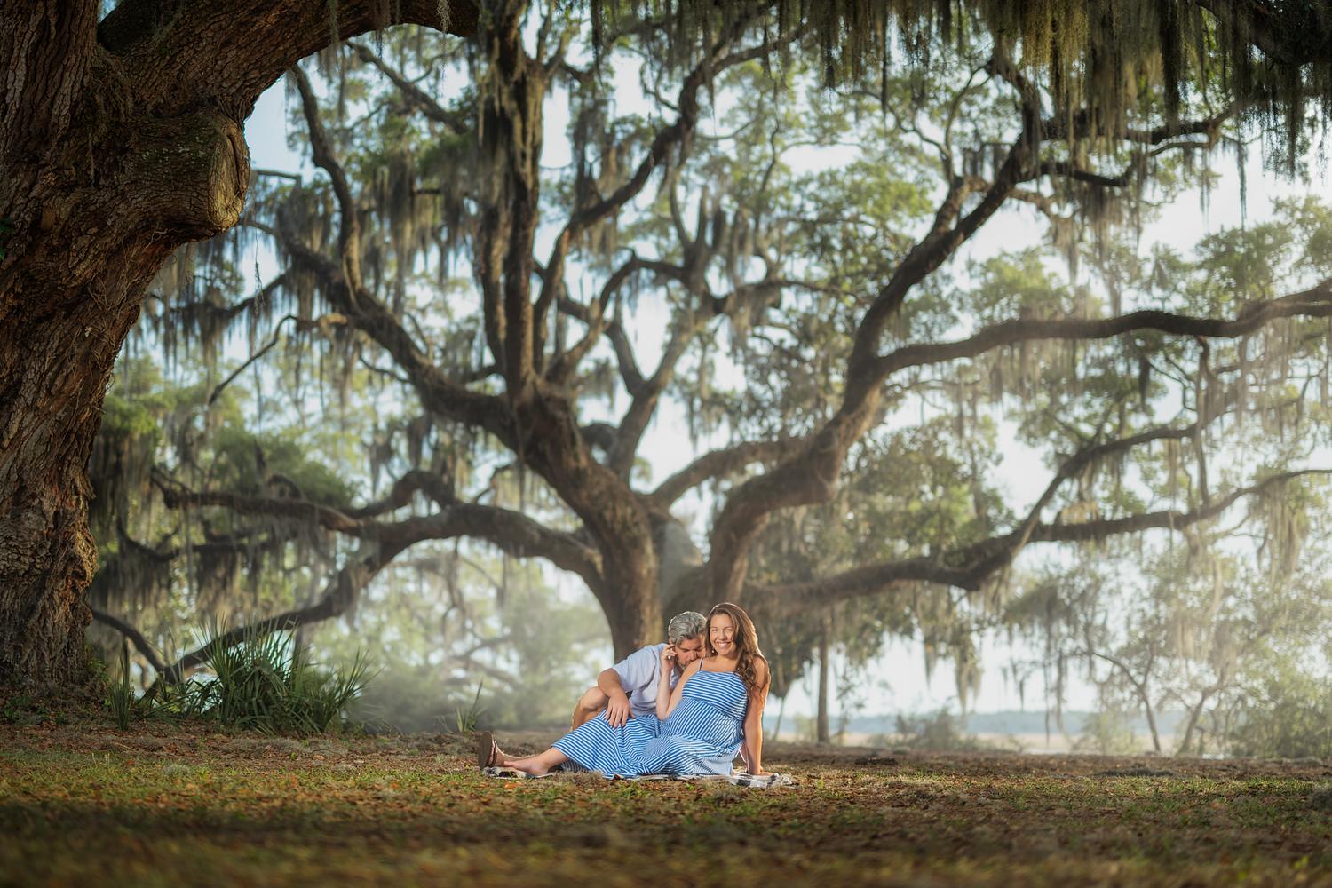 Pregnant woman posing in a forest during a maternity photography session in Savannah, Georgia.
