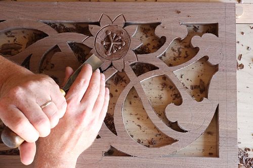 Passion Flower being carved by hand in the walnut door panel