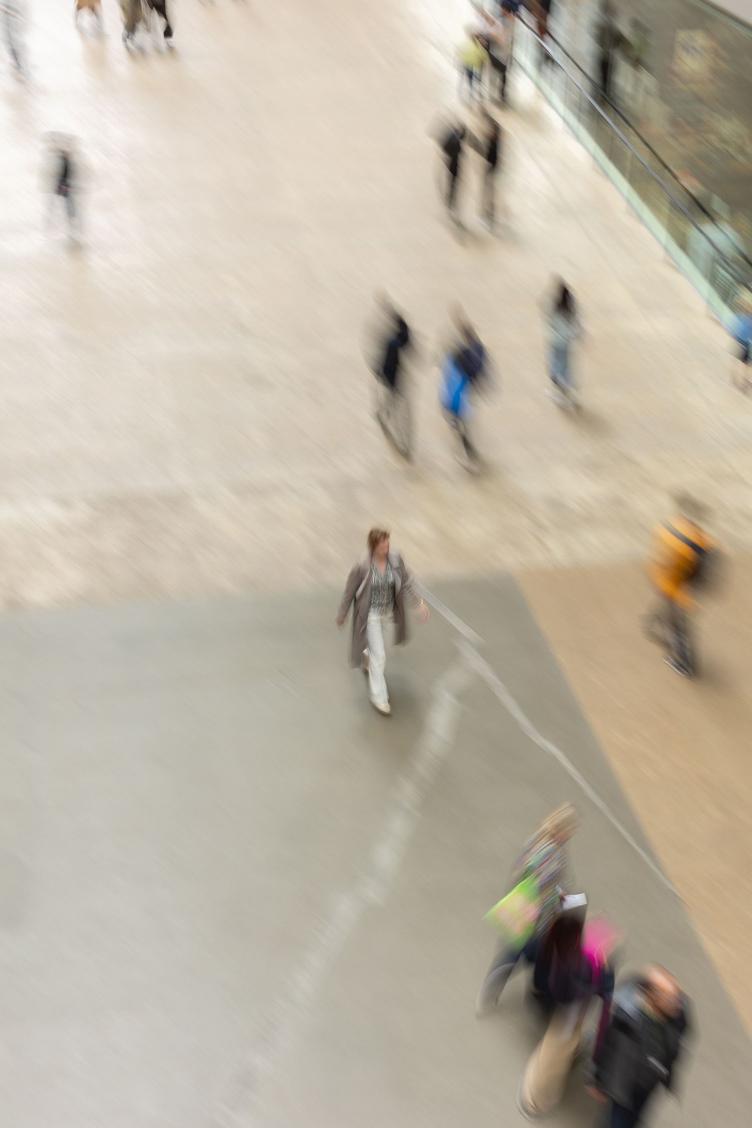 Top view of blurred people walking indoors, motion photography