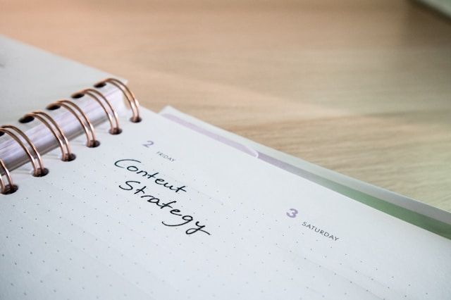 Scrivania con un planner con la scritta Content Strategy sopra