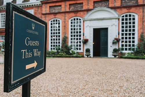 Sign and driveway to wedding entrance