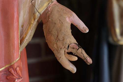 Badly broken hand on the Sacred Heart statue from the backside