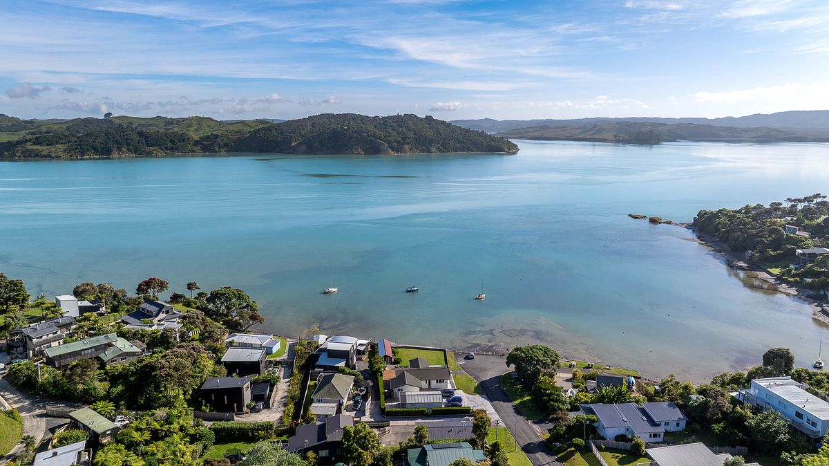 Aerial drone photography of waterfront real estate in Lorenzen Bay, Raglan by Flax Cove Studio.