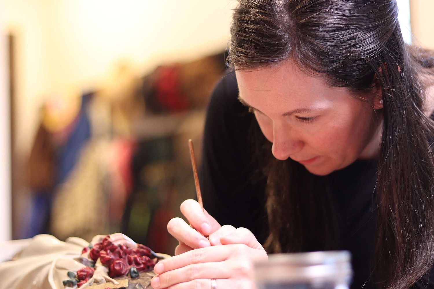 Kelly Baker repainting the very small St Therese statue for St. Leo Oratory in Columbus, Ohio