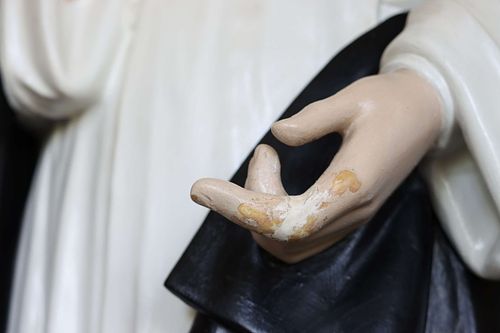 Statue hand in need of repair and repainting