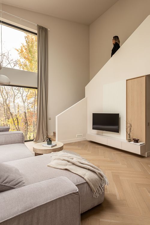 Living room interior with soft light and subtle human presence &ndash; Faget project