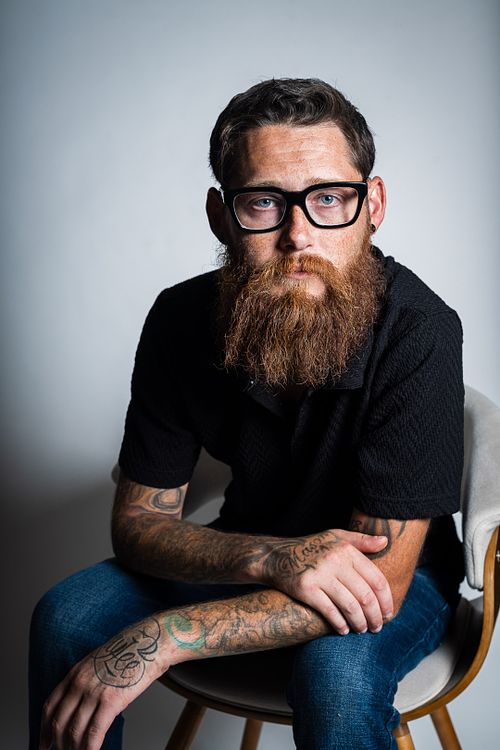 Creative angle studio portrait of Tim with strobes on white background — contemporary portrait by David Andrade, Las Vegas