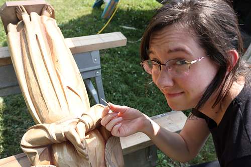 Kelly Baker finding a large wood chip while cleaning statue