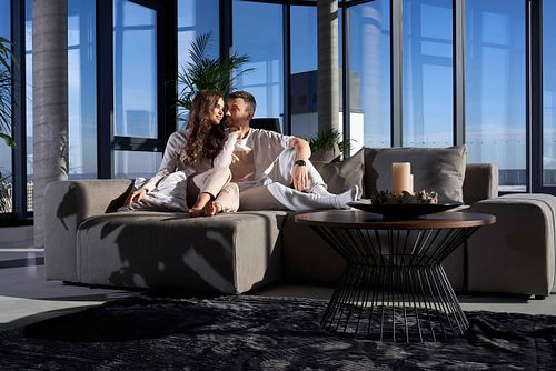 Happy couple resting at home with good mood.