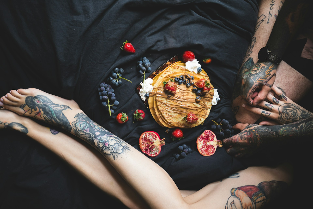A tattoed leg in black background