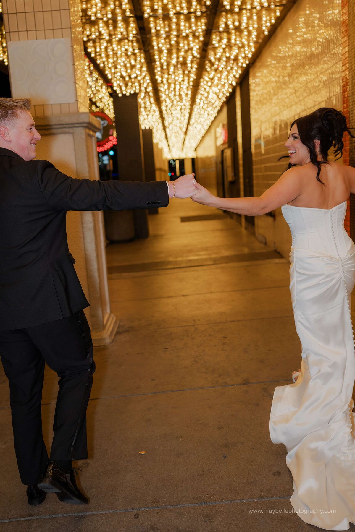 Romantic elopement photos at Carousel Bar in Downtown Las Vegas with couple celebrating with champagne