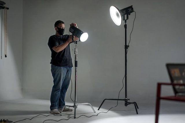 Image of a photographer setting up lighting indoors