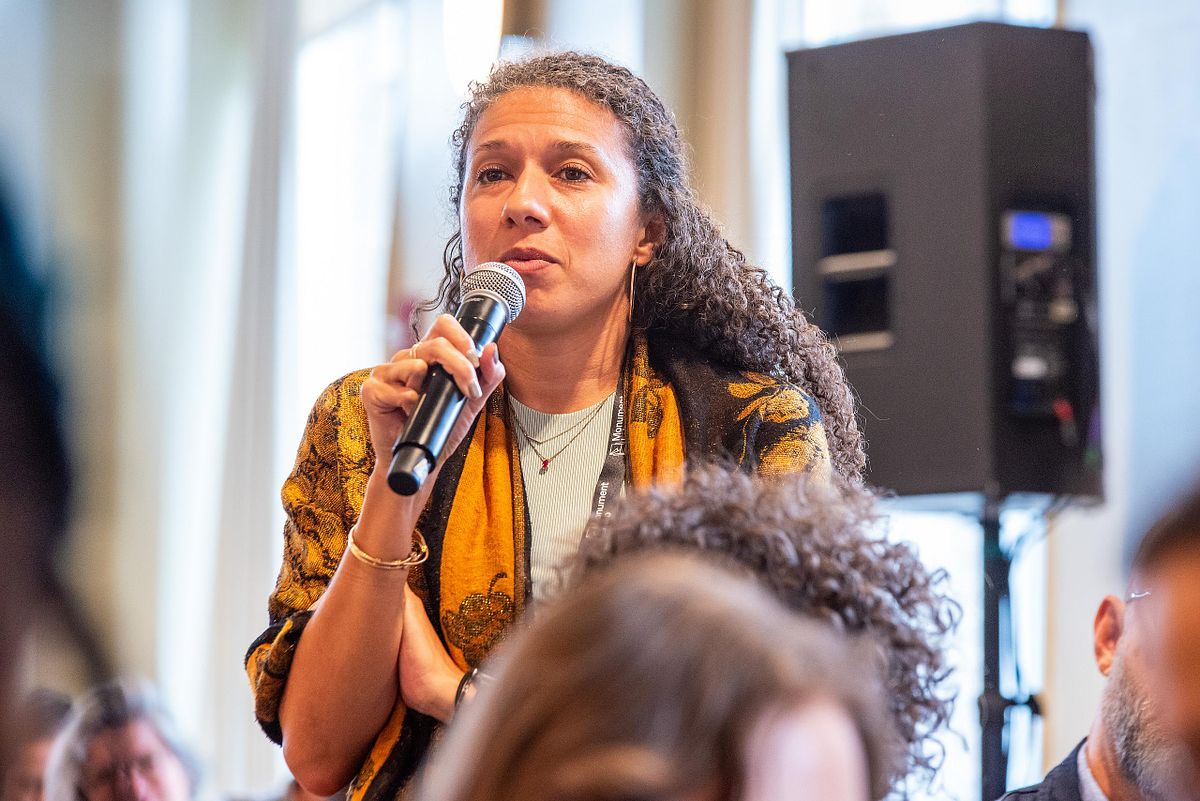 Corporate event photography capturing an attendee asking a question during a leadership conference Q&A session in Philadelphia, highlighting authenticity, voice, and professional presence.