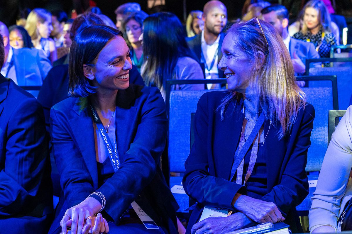 Corporate event photography capturing two attendees sharing a lighthearted conversation during the Clinton Global Initiative in New York City, highlighting authentic connection, collaboration, and leadership.