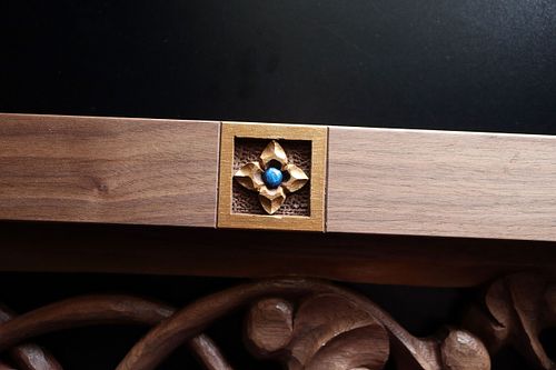 carving of virgin's bower flower in border of custom door panel