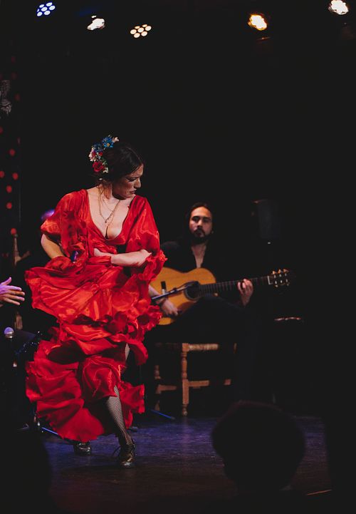 Flamenco dancer performing on stage in Jerez, expressive movement and dramatic lighting