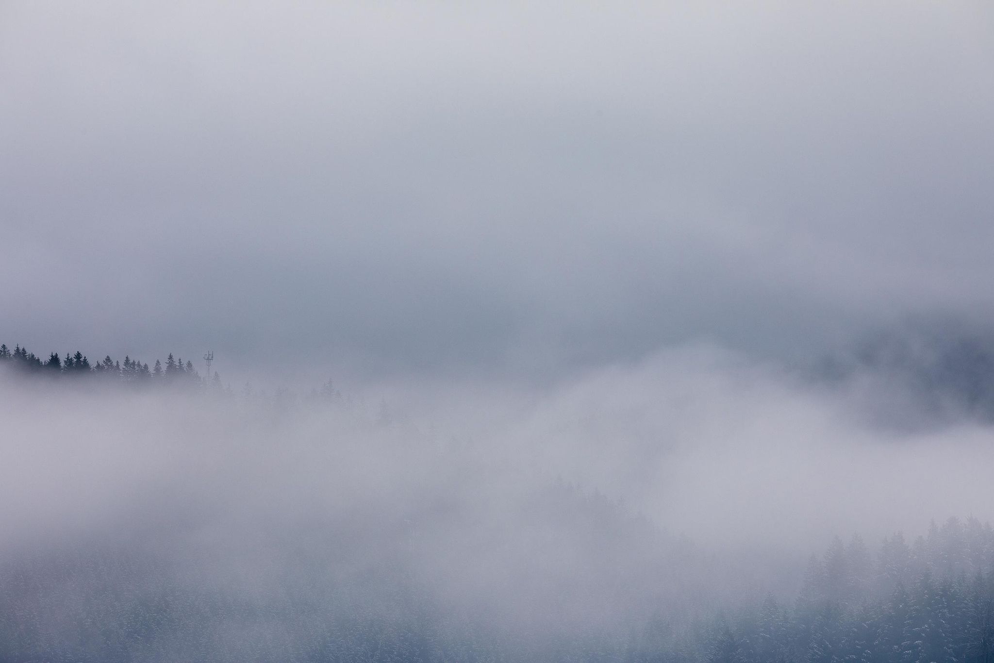 Minimal mountain ridge barely visible through soft mist – atmospheric photography