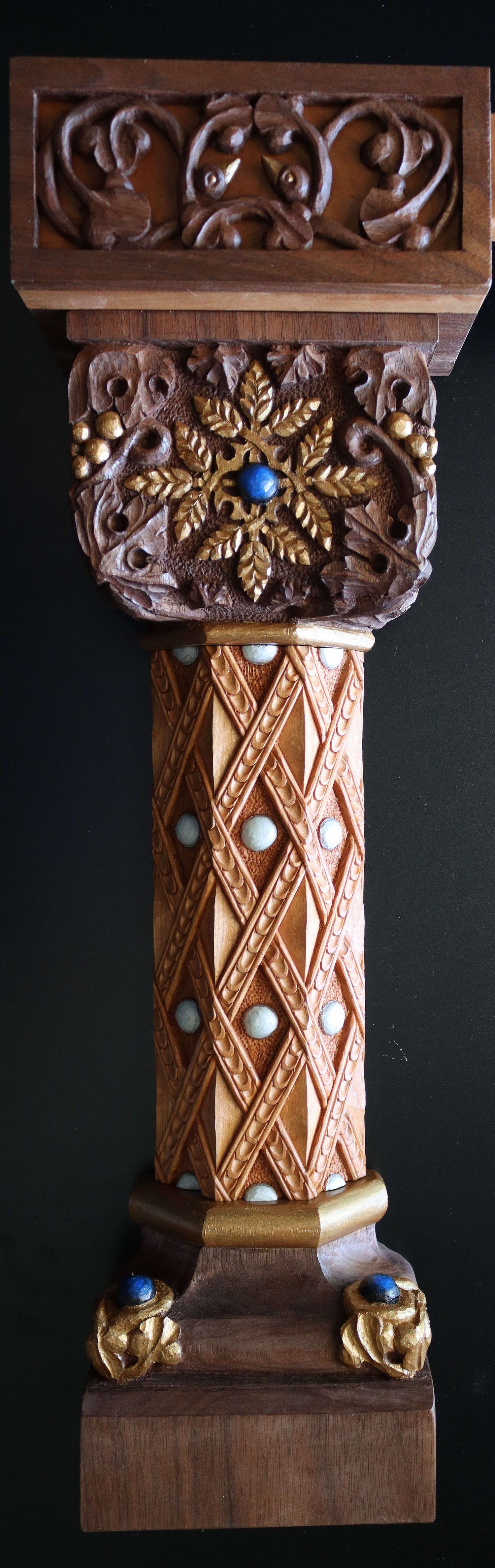 highly carved column for tabernacle in Catholic Church with symbolic wheat, grapes and birds