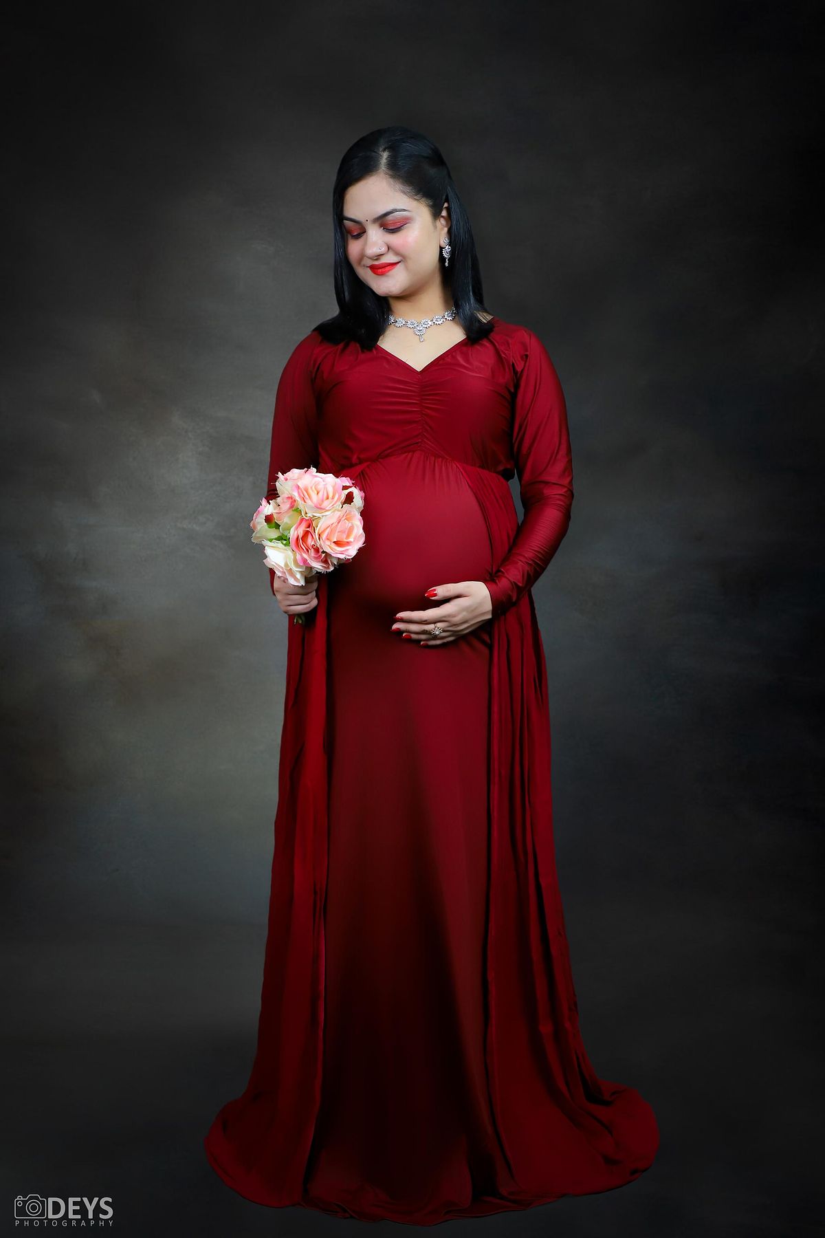 Maroon gown maternity studio photoshoot in Delhi