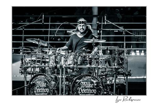 Mike Portnoy Live Concert Print  Horizontal black and white image of Mike Portnoy performing behind a large double bass drum kit during a live concert