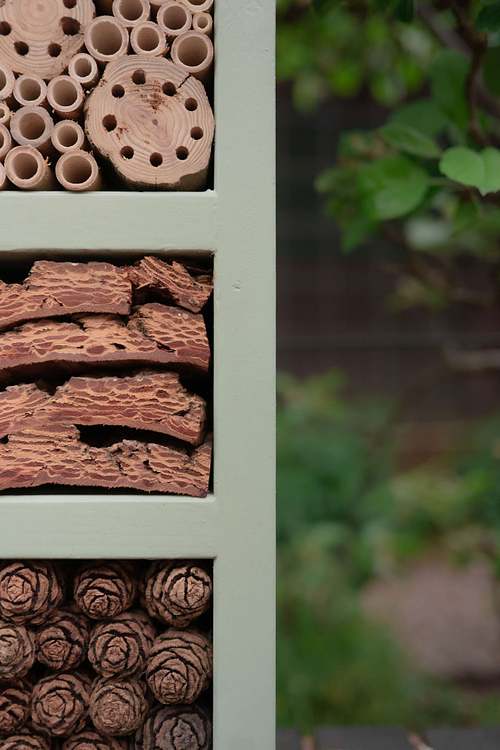 Close-up of natural materials used inside a bee and bug house for wildlife habitats