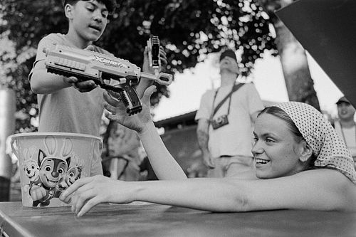 black and white film photo of group playing a game
