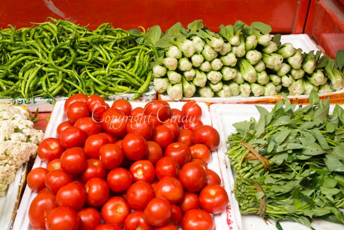 Colorful fresh vegetable display in Chinese market stand