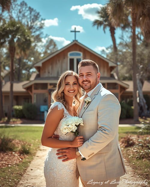 A bride and groom embracing in front of a rustic wooden farmhouse at an Ocala horse farm wedding in Marion County, FL.