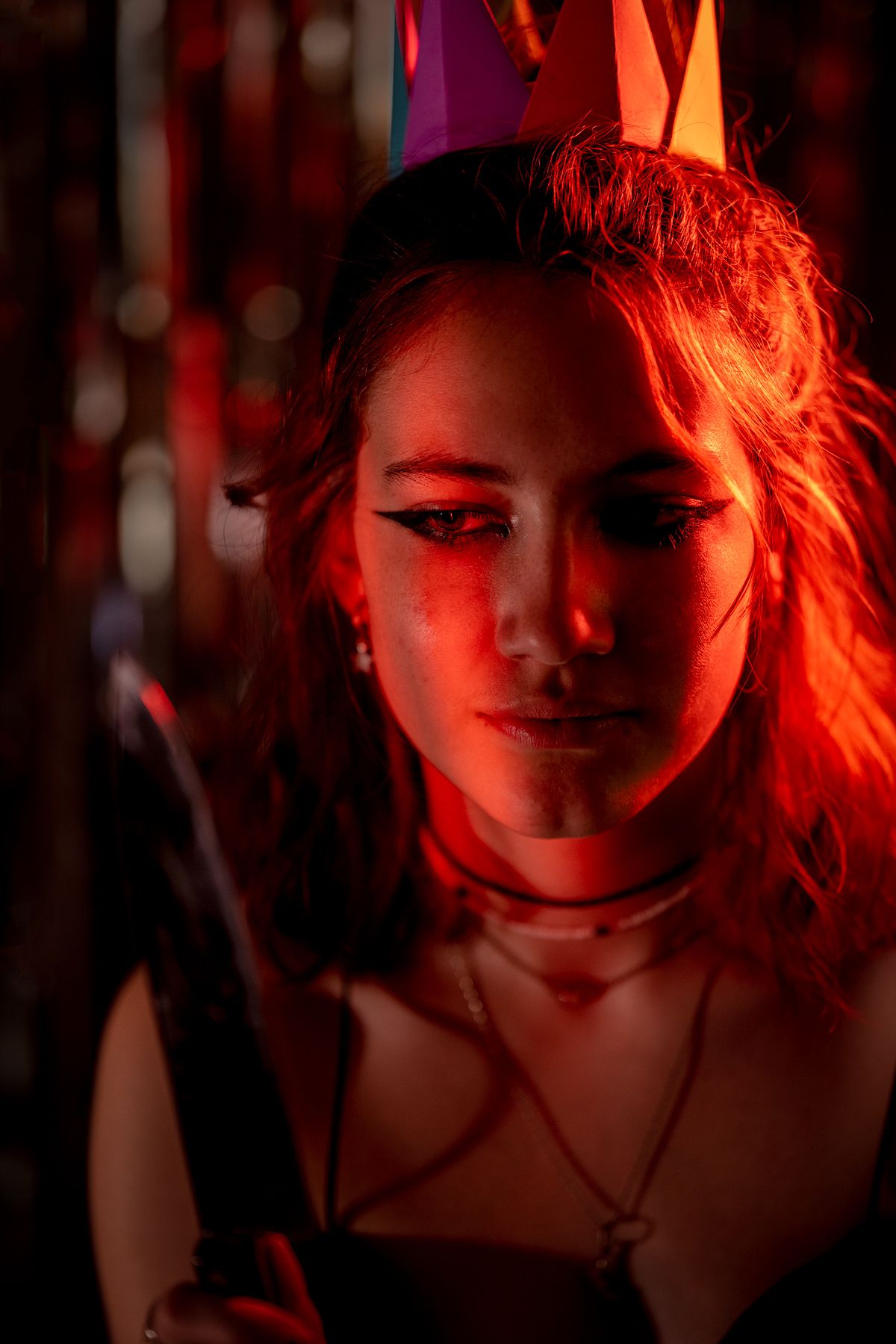 Portrait of young girl looking into a knife.