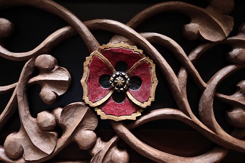 wood carved poppy flower by Wes Baker in walnut and painted red, gold, and black for a shrine to the Sacred Heart of Jesus