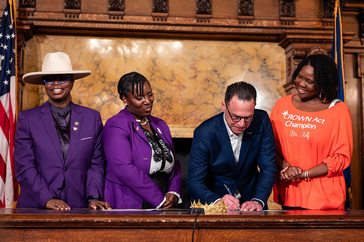 Governor Josh Shapiro signs the CROWN Act into law at the Pennsylvania Capitol surrounded by advocates and supporters